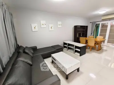 Spacious living room with modern furniture and dining area, perfect for family gatherings.