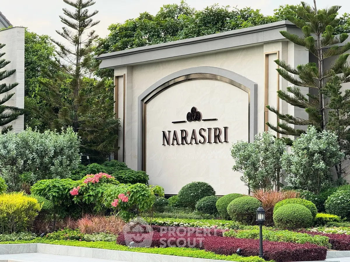 Elegant entrance of Narasiri with lush landscaping and sophisticated signage.