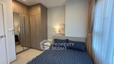 Cozy bedroom with stylish mirrored wardrobe and soft lighting, perfect for relaxation.