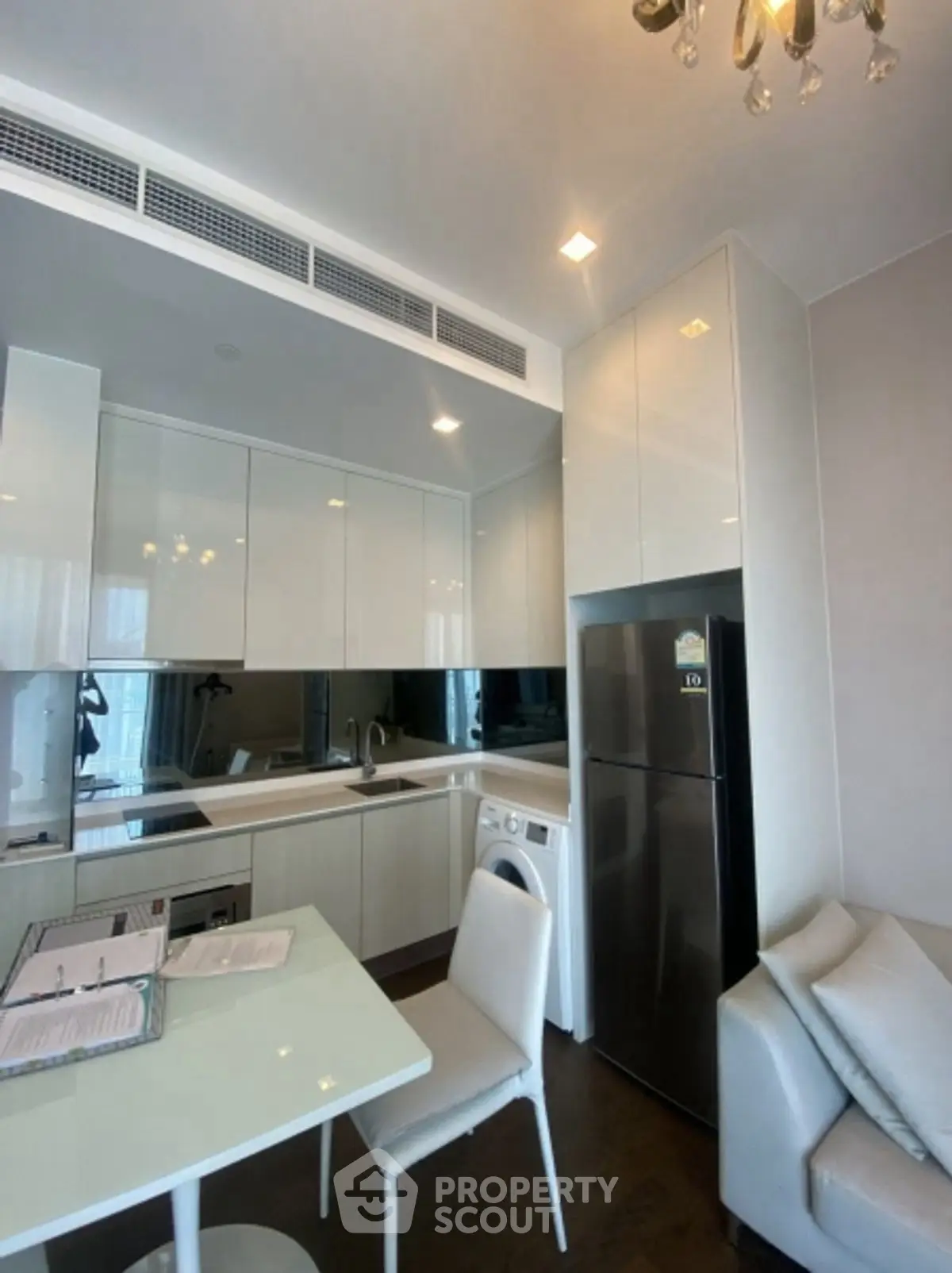 Modern kitchen with sleek cabinetry and integrated appliances in a stylish apartment.