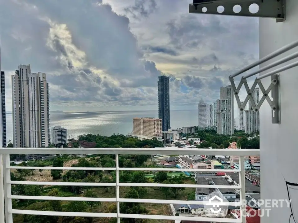 Stunning high-rise balcony view overlooking city skyline and ocean horizon