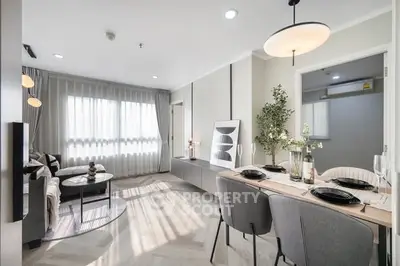 Modern living room with dining area, stylish decor, and natural light.