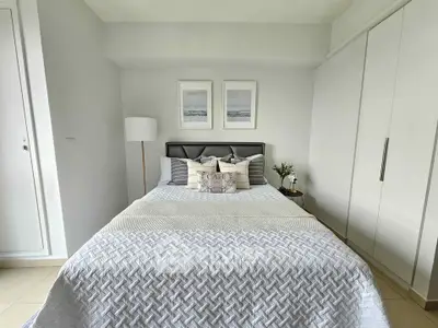 Cozy bedroom with modern decor and ample natural light