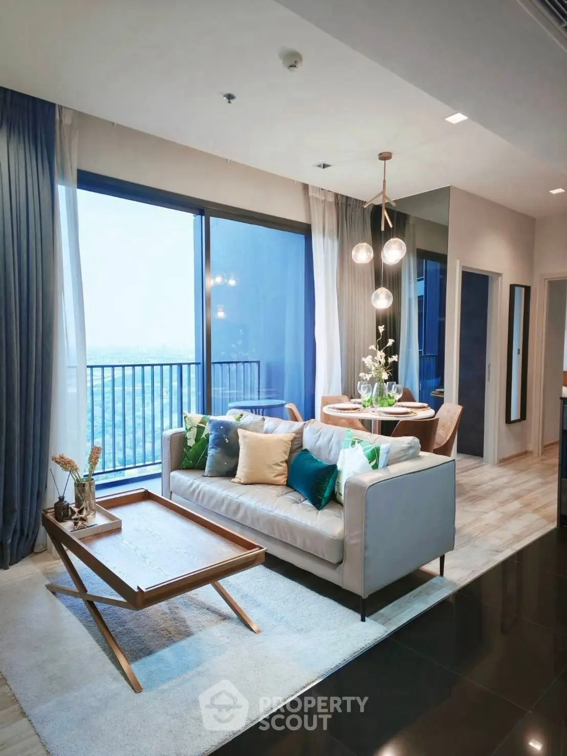 Modern living room with elegant decor and stunning city view from the balcony.