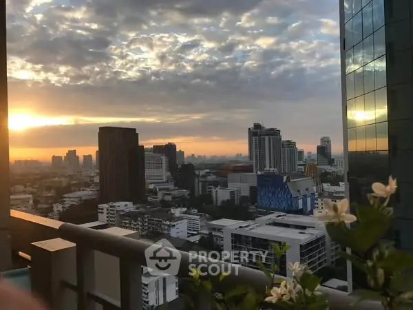 Stunning cityscape view from a high-rise balcony at sunset, perfect for urban living.