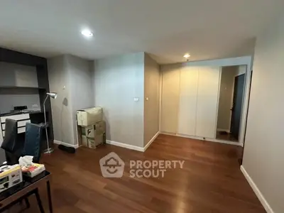 Spacious modern living area with wooden flooring and built-in storage