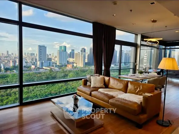 Luxurious living room with stunning city view and modern furnishings in high-rise apartment.