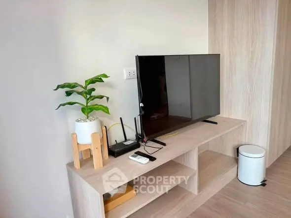 Modern living room with sleek TV setup and stylish wooden furniture