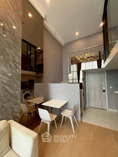 Modern duplex apartment with stylish dining area and high ceilings