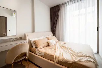 Elegant bedroom with cozy bed and natural light through sheer curtains, perfect for relaxation.