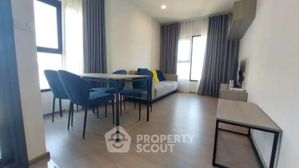 Modern living room with stylish furniture and large windows for natural light.