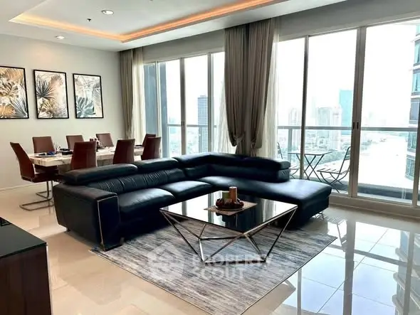 Luxurious living room with modern black leather sofa and stunning city view.