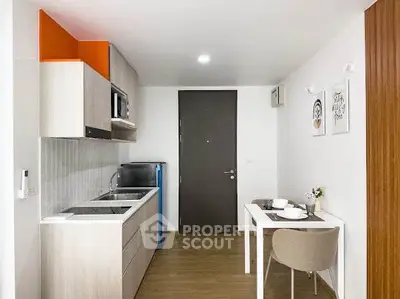 Modern compact kitchen with dining area in stylish apartment