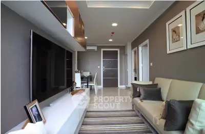 Modern living room with sleek decor and large TV in stylish apartment