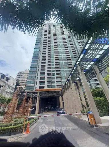 Stunning high-rise building with modern architecture and lush landscaping in urban setting.