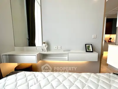 Modern bedroom with sleek white furniture and cozy lighting, perfect for a stylish urban lifestyle.
