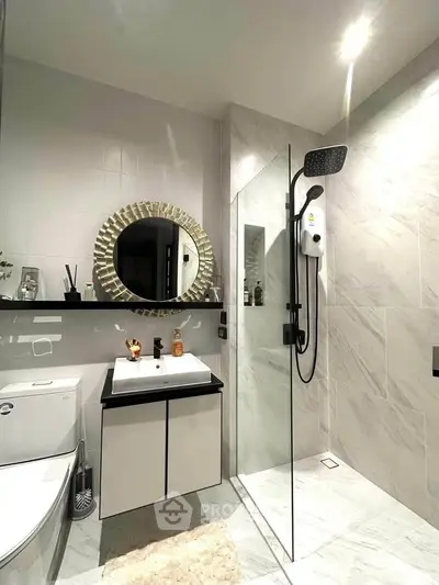 Modern bathroom with sleek shower, stylish mirror, and elegant fixtures in a contemporary design.