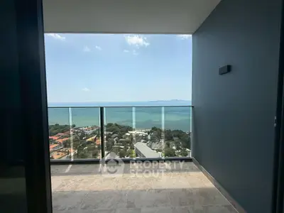 Stunning ocean view from a modern balcony in a high-rise apartment, perfect for relaxation and enjoying sunsets.