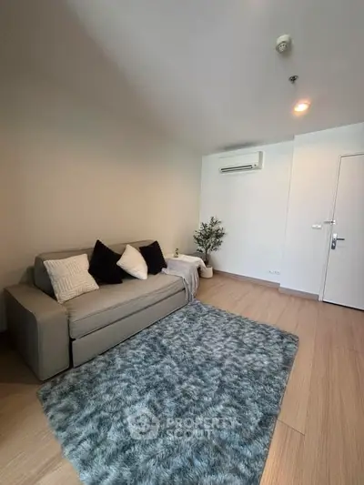 Modern living room with cozy sofa and plush rug in stylish apartment