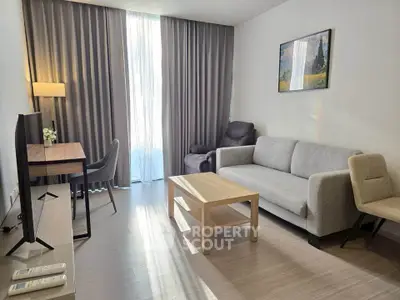 Modern living room with sleek furniture and natural light, perfect for relaxation and work-from-home setup.