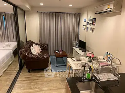 Chic modern living room with cozy leather sofa and stylish decor in open-plan apartment.