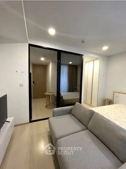 Modern living room with sleek design and cozy ambiance, featuring a stylish sofa and elegant decor.