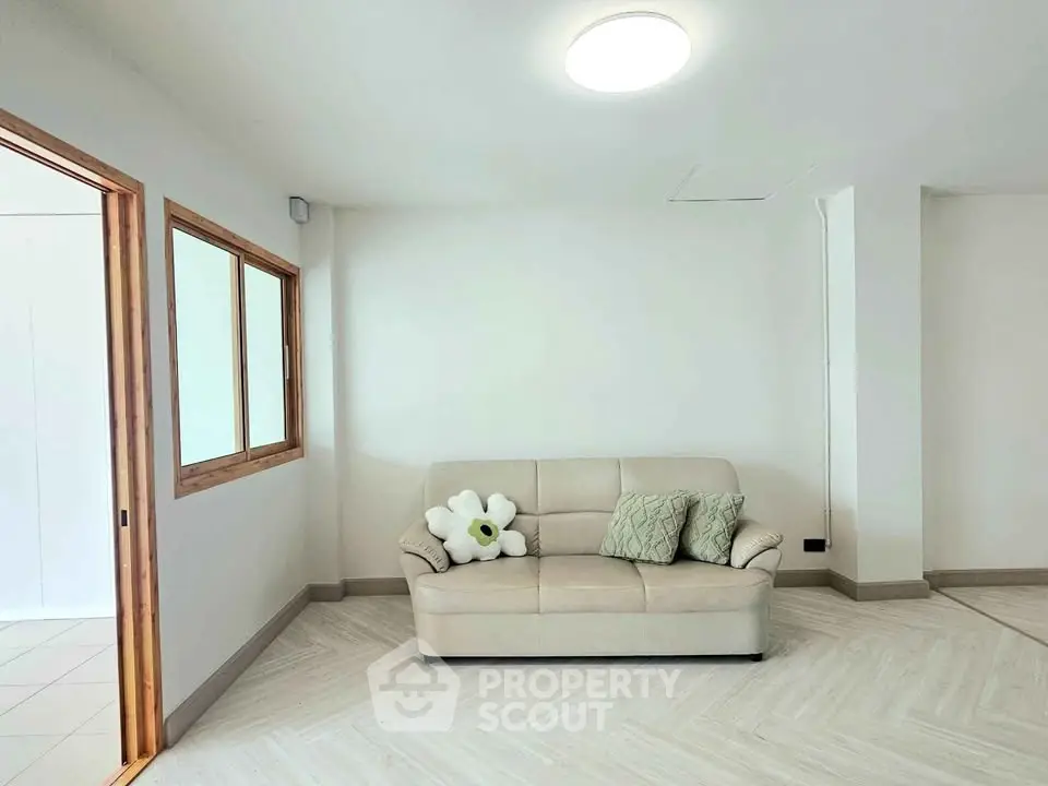 Spacious living room with cozy beige sofa and modern decor