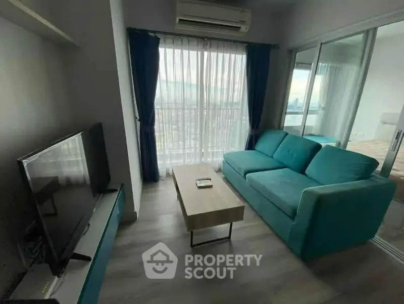 Modern living room with teal sofa and city view from window