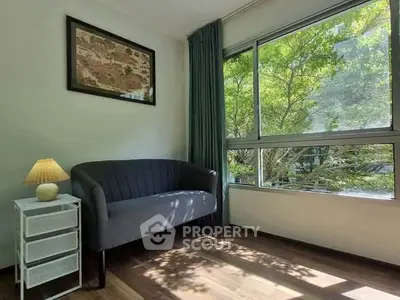 Bright living room with large window and cozy seating area