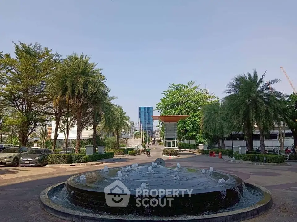 Stunning entrance with a grand fountain and lush greenery, perfect for luxury real estate appeal.