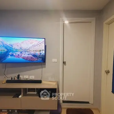 Modern living room with wall-mounted TV and sleek storage unit