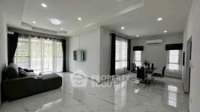 Spacious modern living and dining area with elegant decor and natural light.
