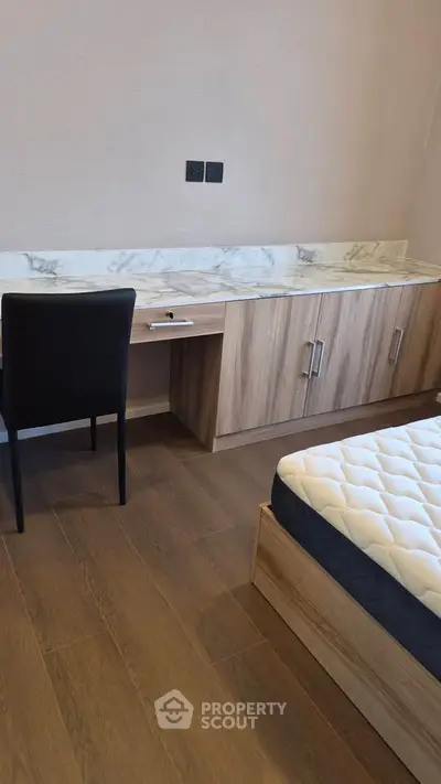 Modern bedroom with stylish wooden furniture and comfortable mattress