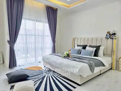 Luxurious bedroom with elegant decor and large window for natural light