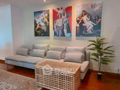 Stylish living room with modern sofa and artistic wall decor