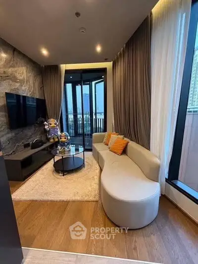 Modern living room with stylish decor and large windows offering city views.
