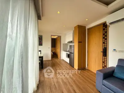 Modern apartment interior with open layout, featuring a cozy living area and sleek kitchen design.