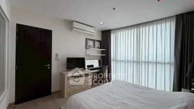 Modern bedroom with large window, stylish furniture, and natural light.