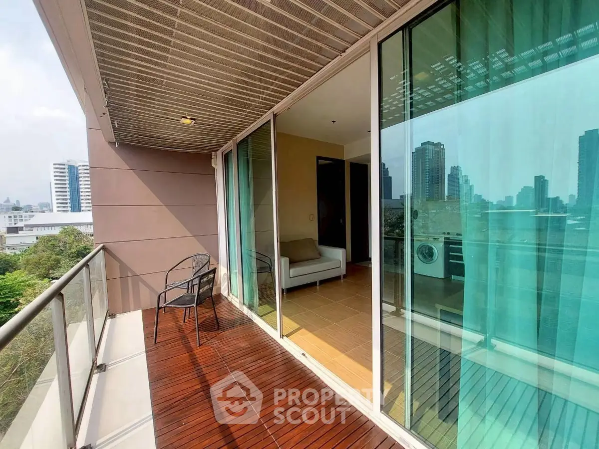 Spacious balcony with city view and modern seating area