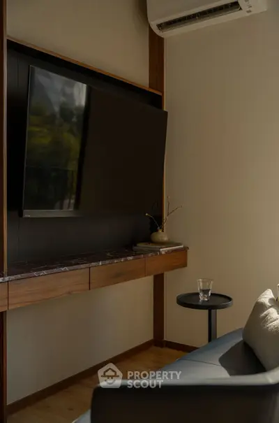 Modern living room with wall-mounted TV and sleek furniture