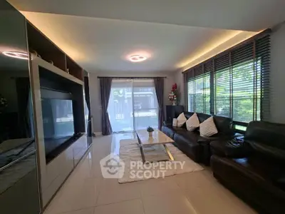 Spacious modern living room with sleek furniture and large windows for natural light.