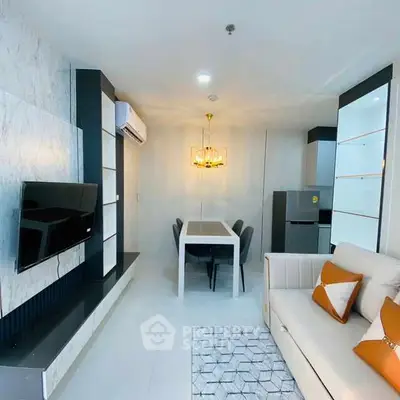 Modern living room with stylish decor and dining area in open layout.