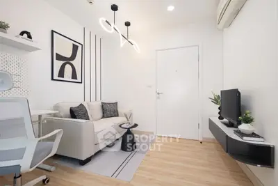 Modern living room with stylish decor, cozy sofa, and sleek TV setup.