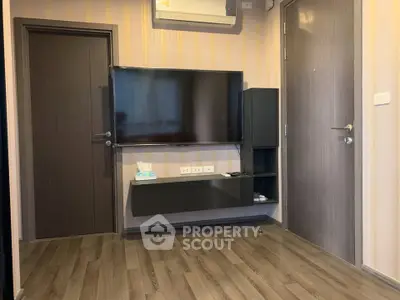 Modern living room with sleek TV setup and wooden flooring