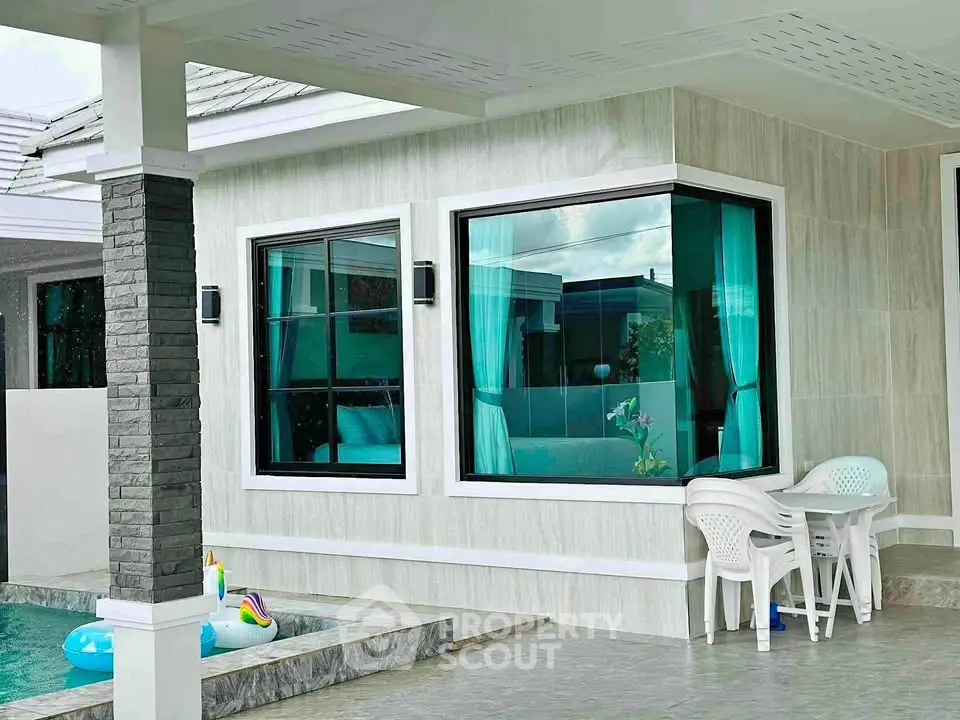 Modern home exterior with pool and stylish windows