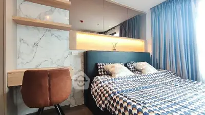 Modern bedroom with stylish decor and ample natural light