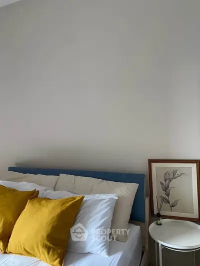 Cozy bedroom with stylish decor and vibrant pillows, perfect for relaxation and comfort.