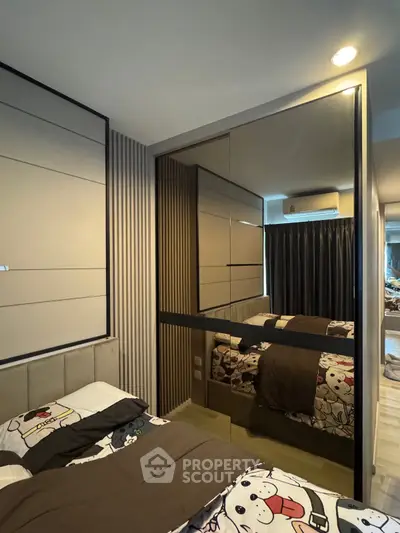 Modern bedroom with mirrored walls and stylish decor