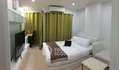 Cozy bedroom with modern decor, featuring a comfortable bed, TV, and workspace, ideal for relaxation and productivity.