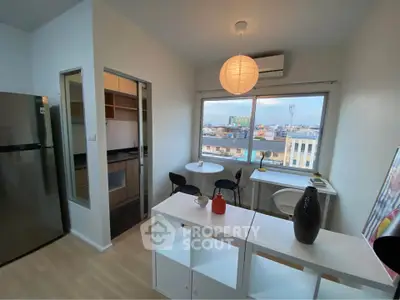 Modern apartment with open kitchen and city view, featuring stylish furniture and ample natural light.